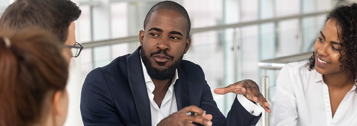 A man speaks to a group of people