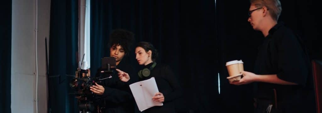 What is screenwriting blog_two women with script talk behind camera