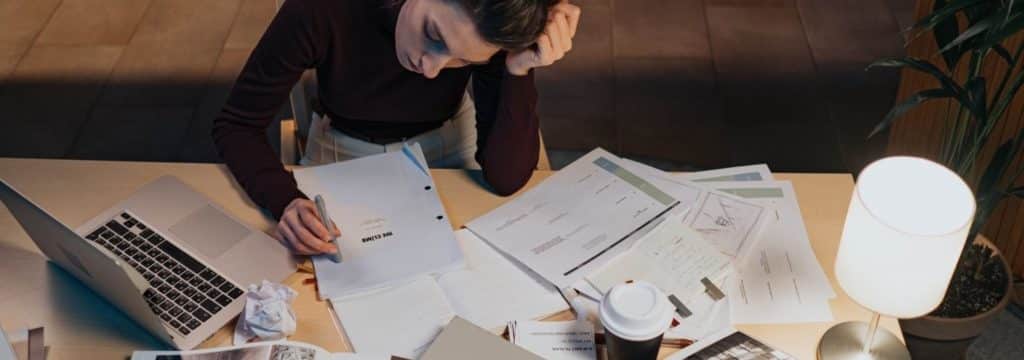 What is screenwriting blog_woman sitting at desk with screenplay