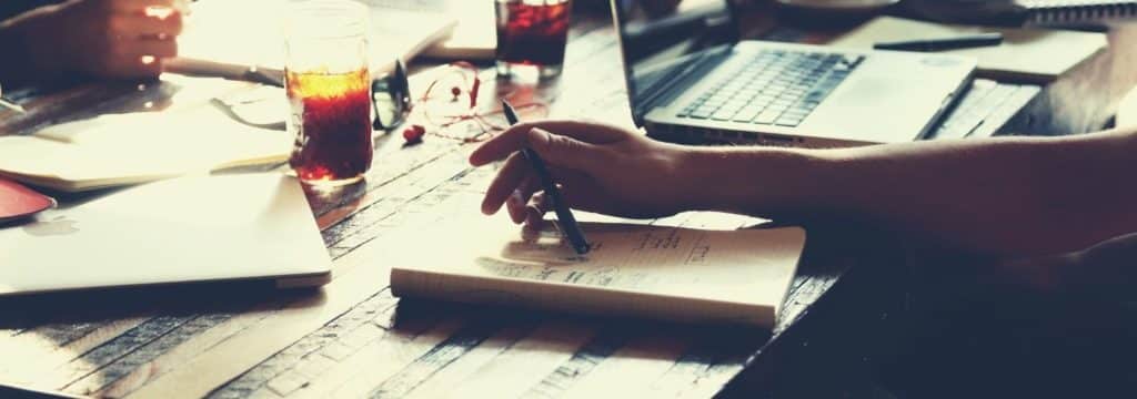 hard to become a professional screenwriter blog_closeup of papers and laptop on desk