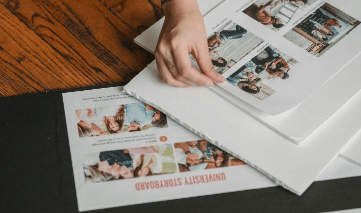 A person putting together a storyboard for university
