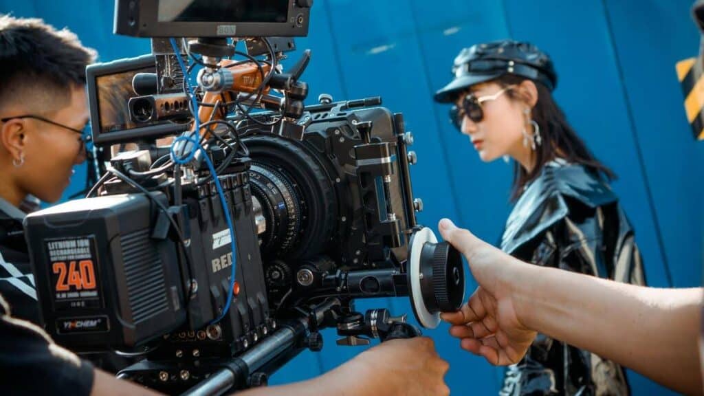 A film crew films a woman wearing all leather