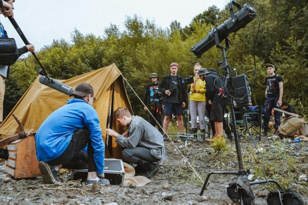 An indie film crew setting up an outdoor campground scene
