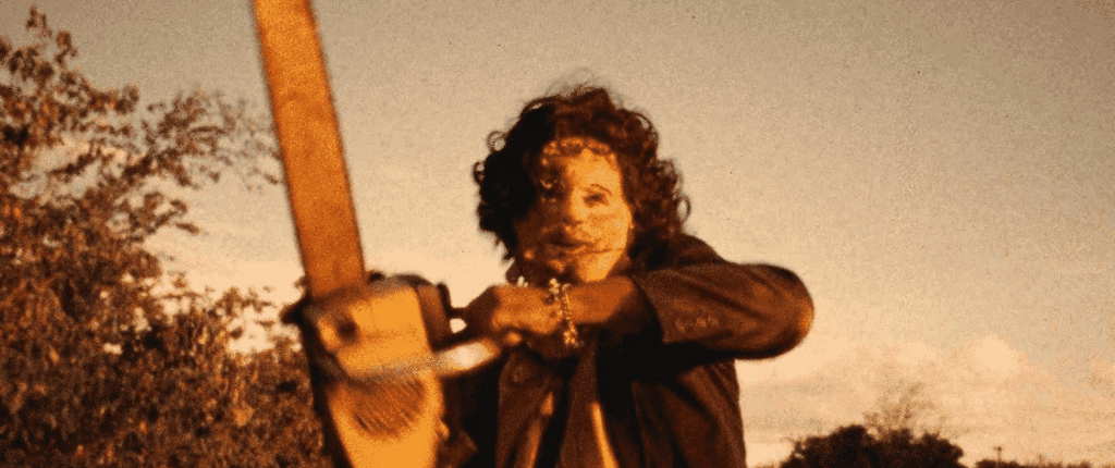 Leatherface holding up his chainsaw