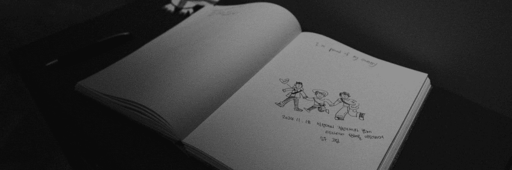 A mostly blank book open to a doodle of 3 people
