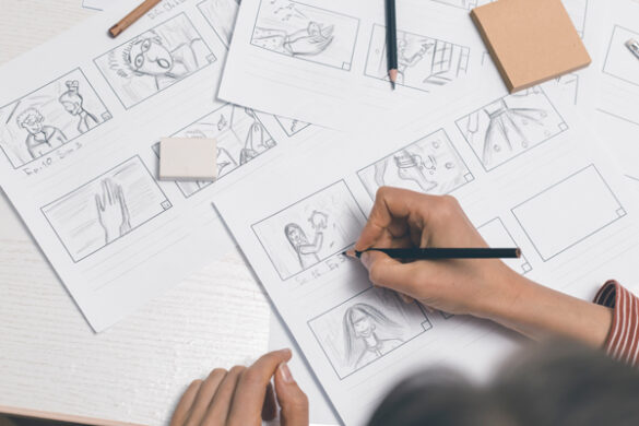 Top down view of hand-drawn storyboard sketches in-progress