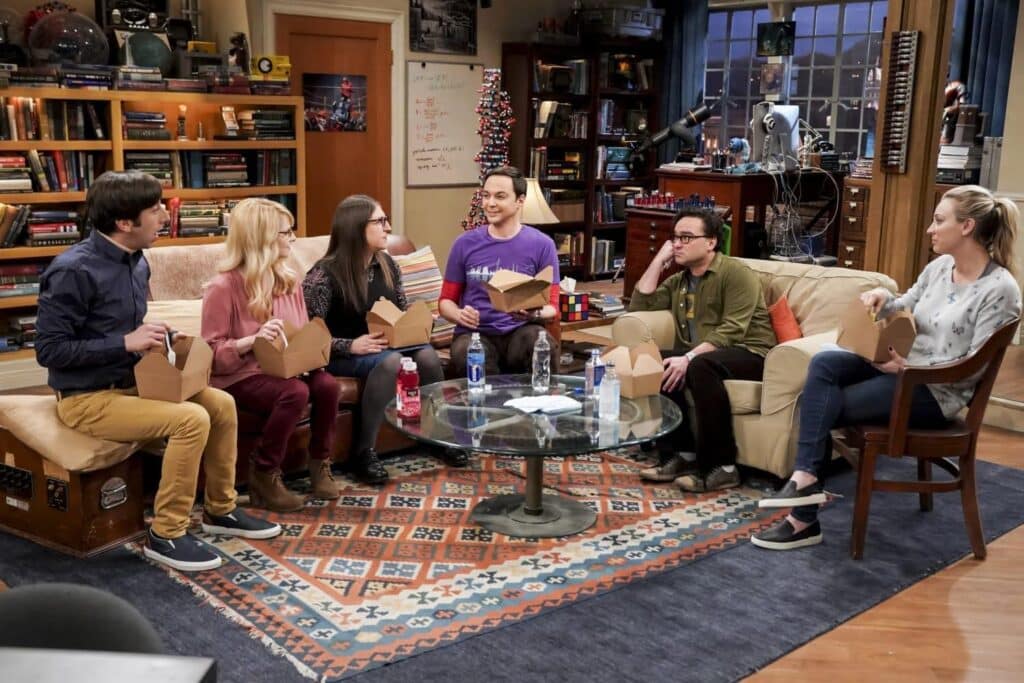 The cast of The Big Bang Theory eating out of takeout boxes
