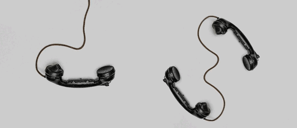 old black telephones (corded) on a white background