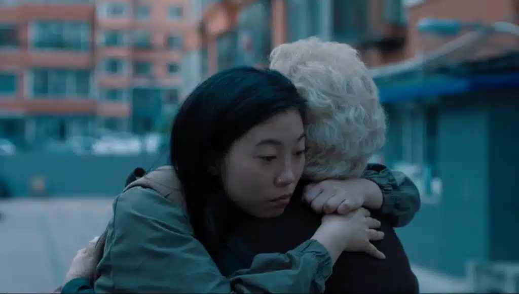 What is an indie film? "The Farewell" from A24. This still from the film shows two characters embracing. One younger and one older.