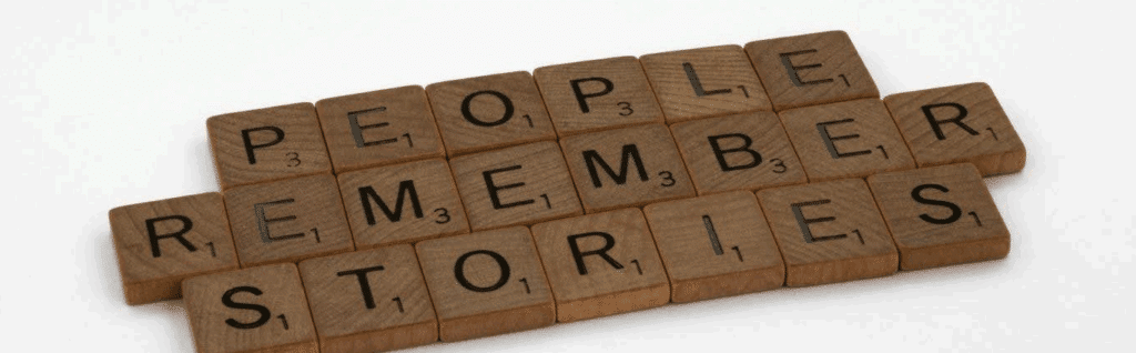 Scrabble tiles spelling out "People remember stories"