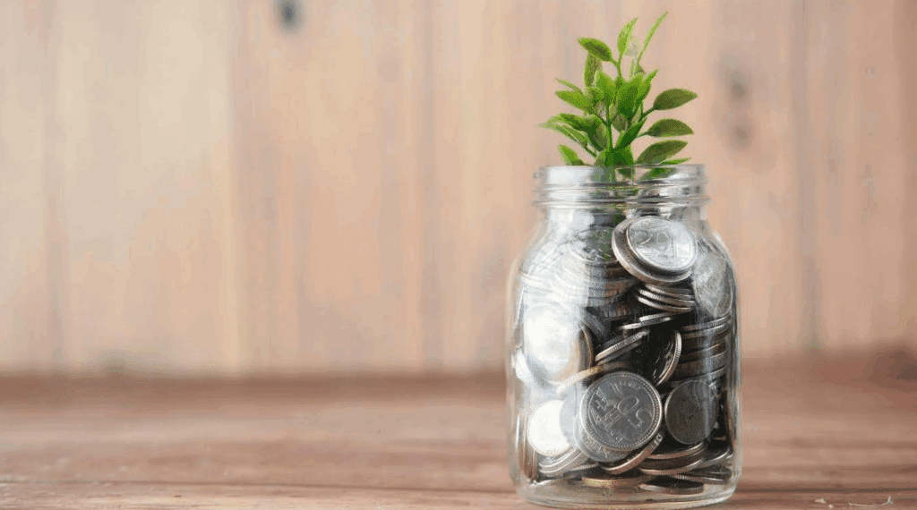 A jar full of silver coins with a little (fake) sprout on top.