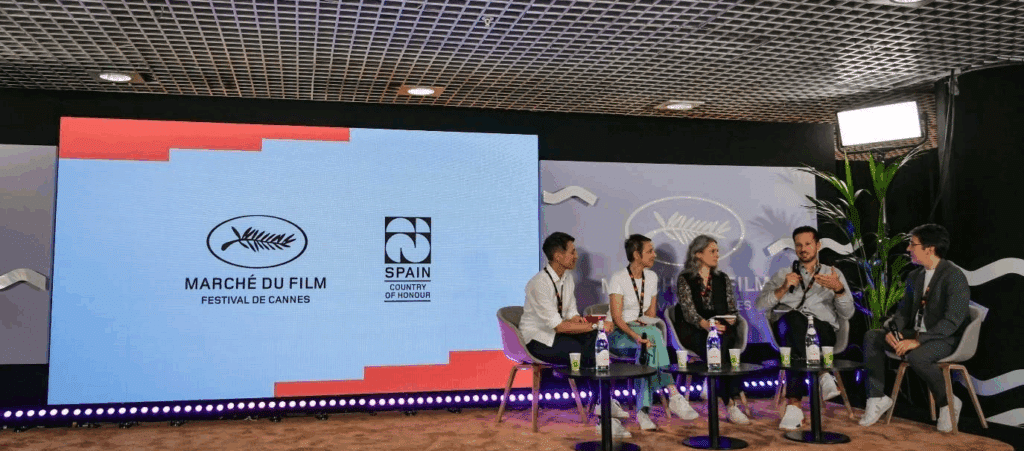 a photo of what looks to be a panel of speakers at Cannes Film Festival