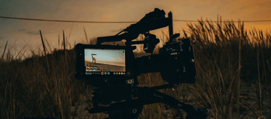 the viewfinder of a camera sat outside in what appears to be a field at sunset