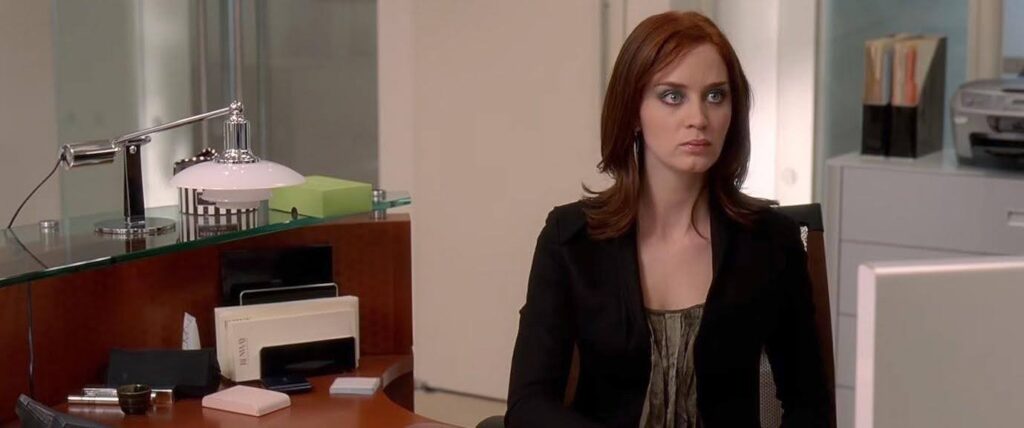 A still of Emily from The Devil Wears Prada who is an example of a flat character that emphasizes other characters.