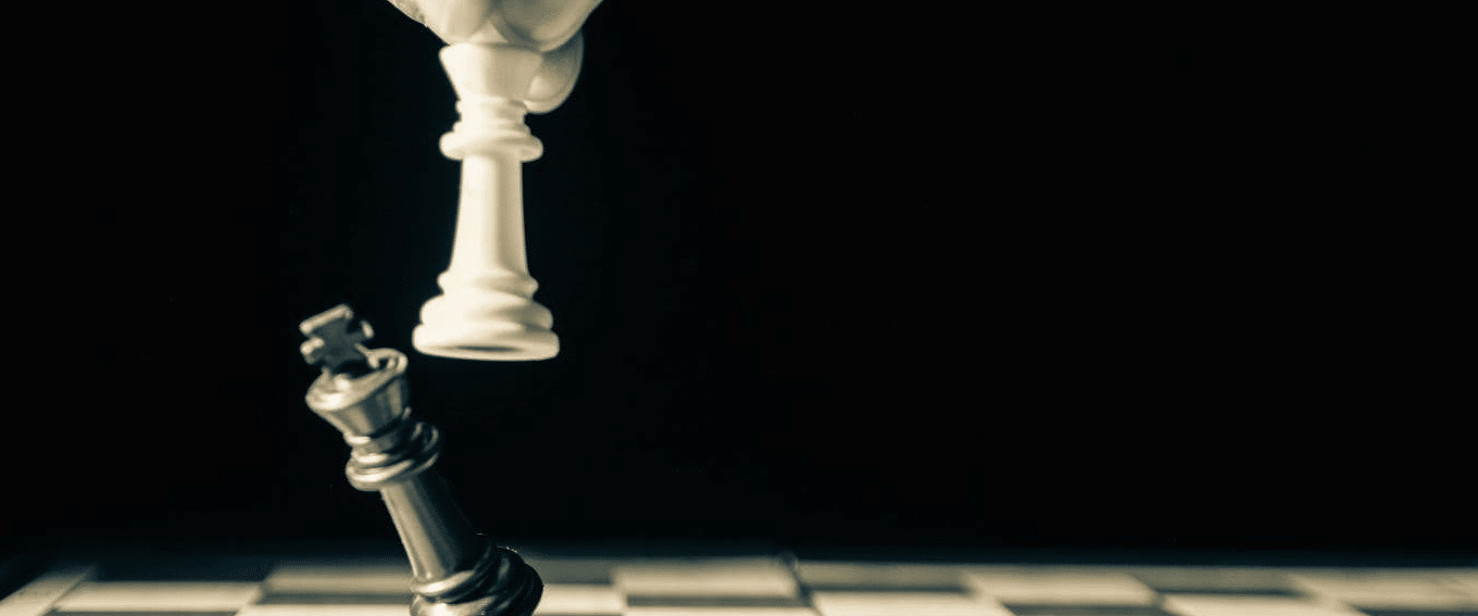 how to create a beat sheet. photo of one chess piece knocking over another