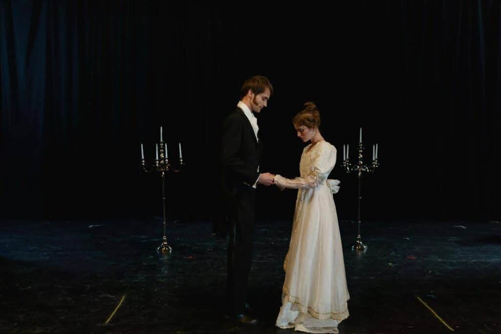 two actors on stage in a play