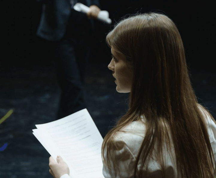A woman rehearses lines for a stage play