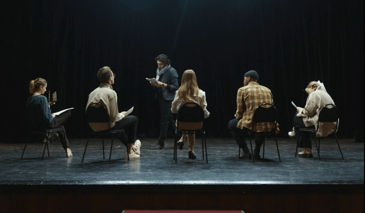 A group of actors rehearse a play