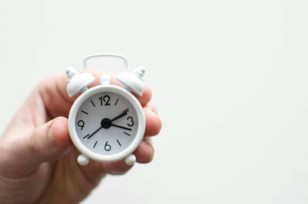 a tiny white alarm clock