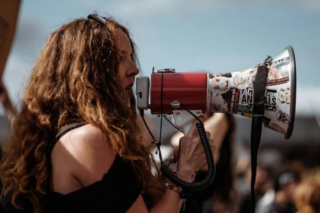 a woman speaks into a megaphone