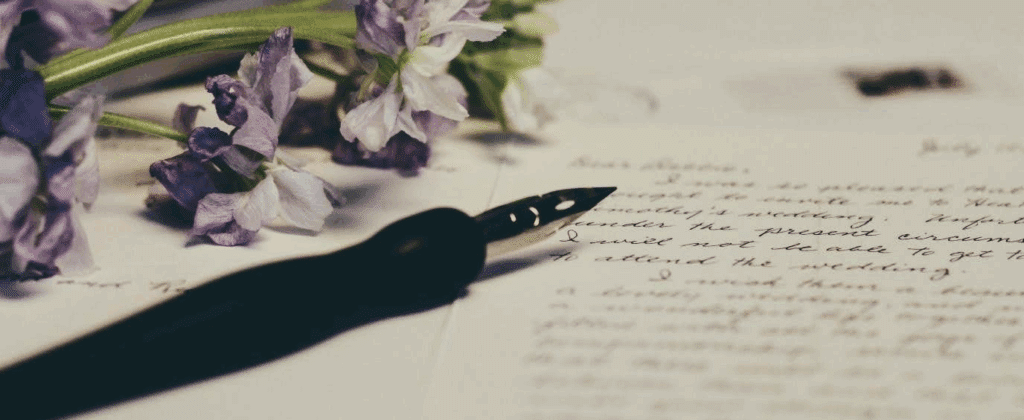 a modern fountain pen, flowers, and a handwritten note.