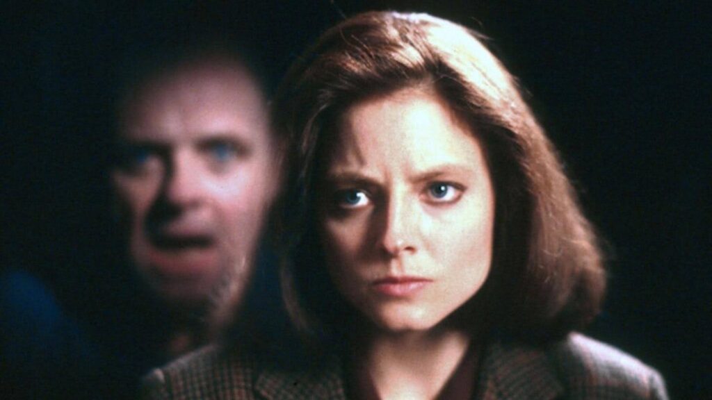 A still from the award-winning horror film: Silence of the Lambs showing Anthony Hopkins' character Hannibal Lecter behind Jodie Foster's character.
You could write the next award winning film with Celtx Screenwriting Software.