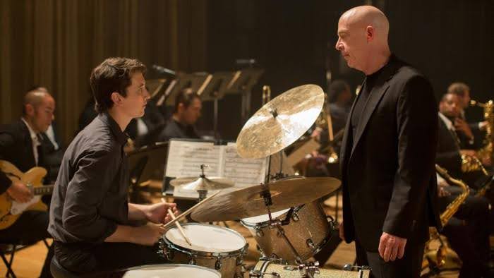 A still from the movie "Whiplash" showing J.K. Simmons and Miles Teller.