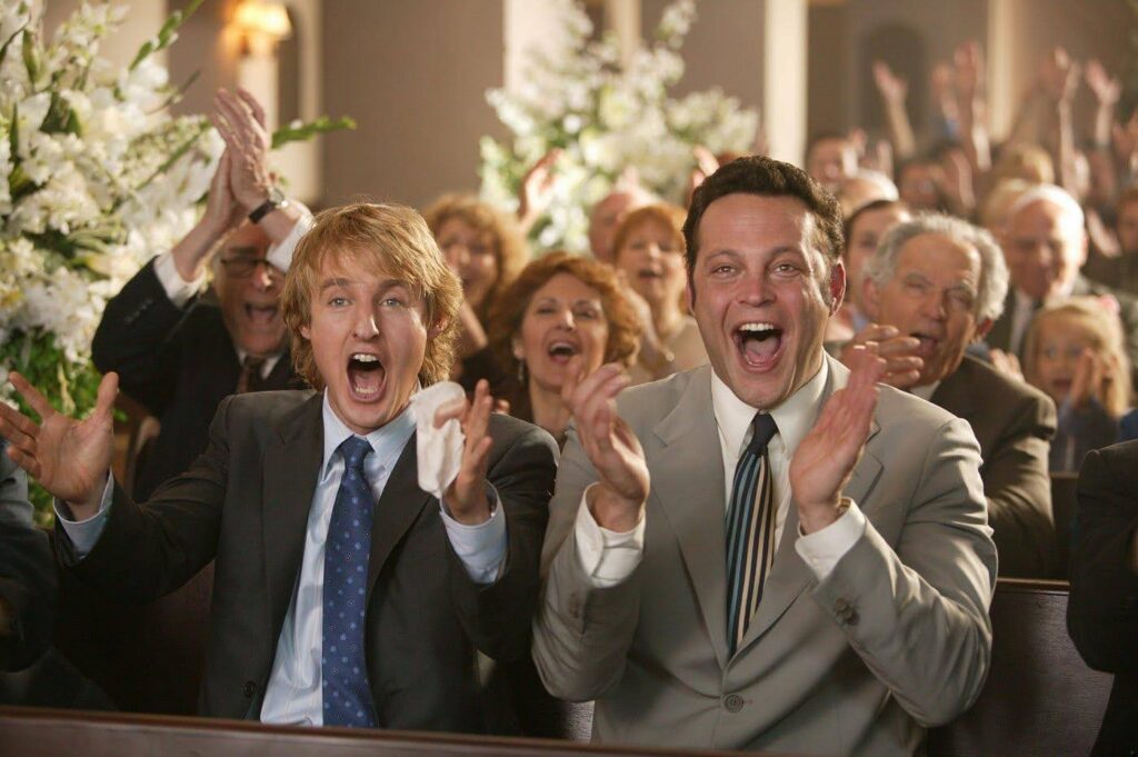 A still from a wedding scene from Wedding Crashers 2 - showing Owen Wilson and Vince Vaughn cheering as someone says "I do."
Write your next hilarious rom-com with Celtx screenwriting software.