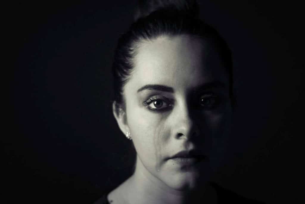 A close-up shot of a woman with a tear streaming down her face. Not to be confused with medium shot, or wide shot.