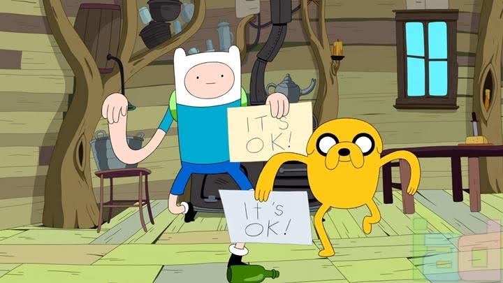 A still from the animated series Adventure Time showing Finn and Jake holding signs that say, "It's OK!"