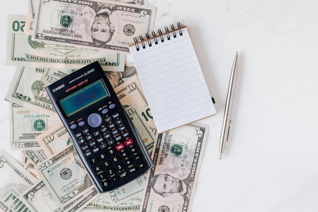 How do you schedule a film production? One of the first steps is budgeting. This photo shows a calculator and notepad on top of a pile of American money.