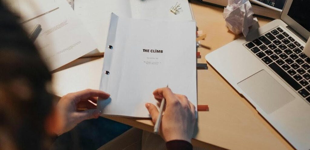 A printed script titled "The Climb," representing character development in storytelling.