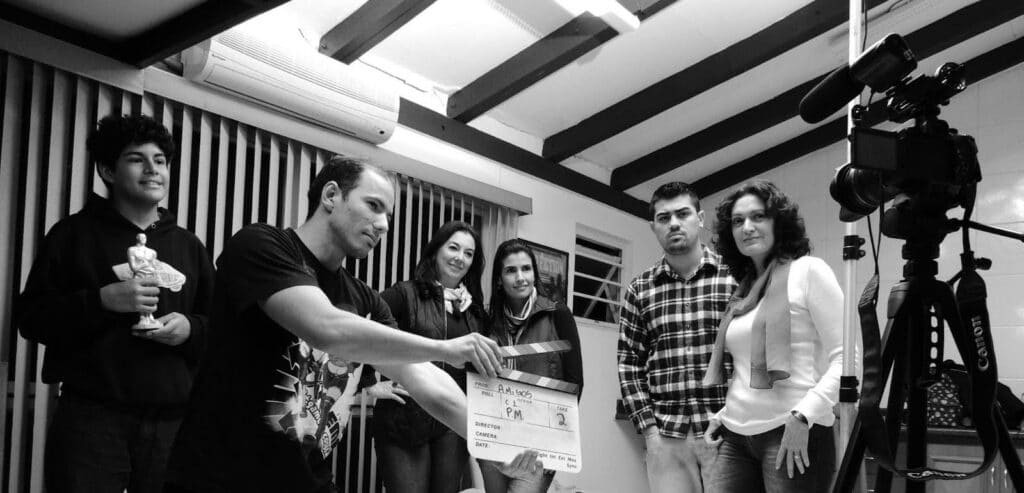 A cast and crew on set about to shoot using script sides.