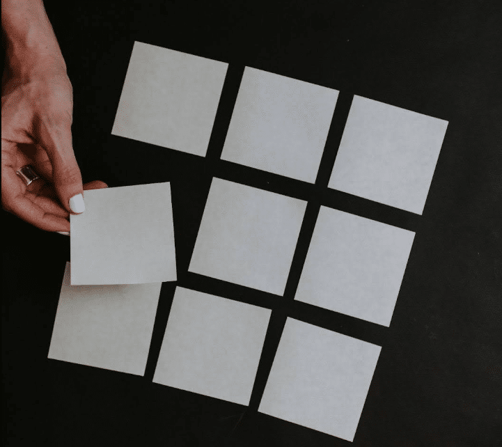 A woman organizes note cards into a story board. Story boarding can help you organize your story and build a solid film treatment.