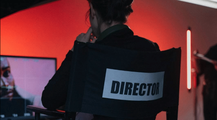 A person sits in a director's chair