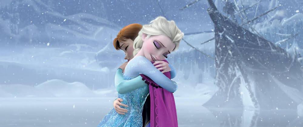 A still from the animated musical: Frozen. Anna & Elsa embrace after the curse has been broken.