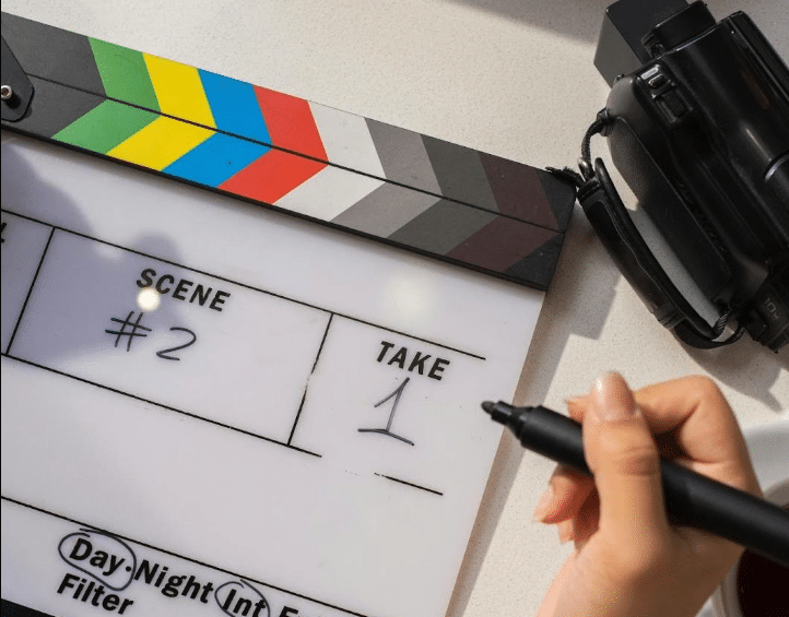 A film clapboard indicating this production is about to shoot the first take of scene 2.