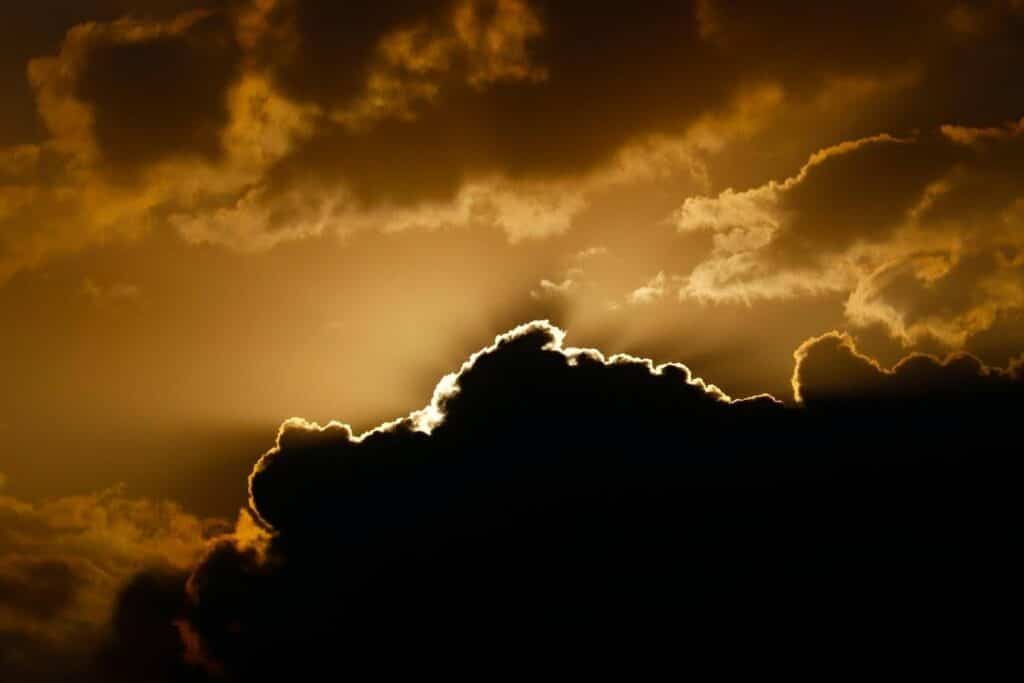 the sun peeks over a cloud