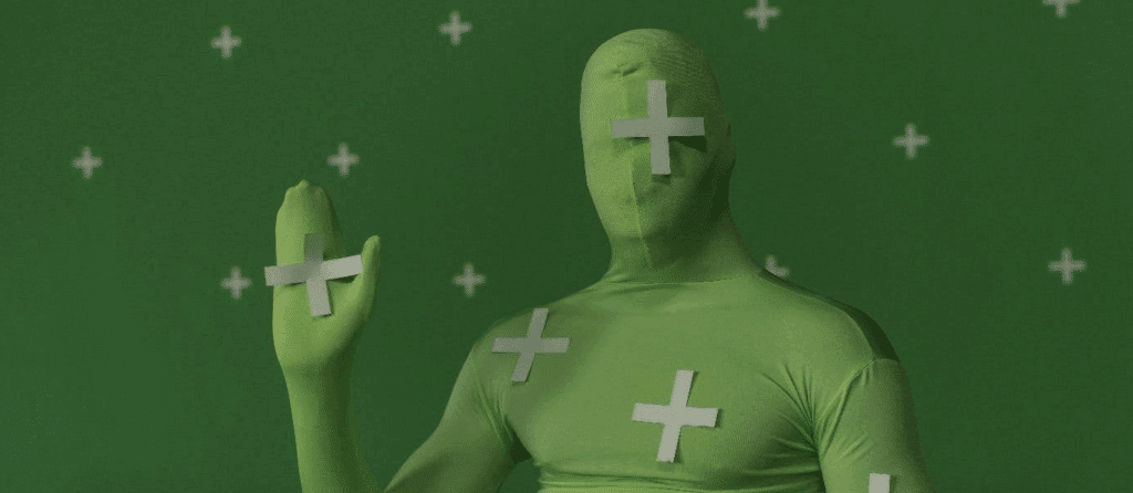 A person wearing a chroma key/VFX suit on a film set. Post production.