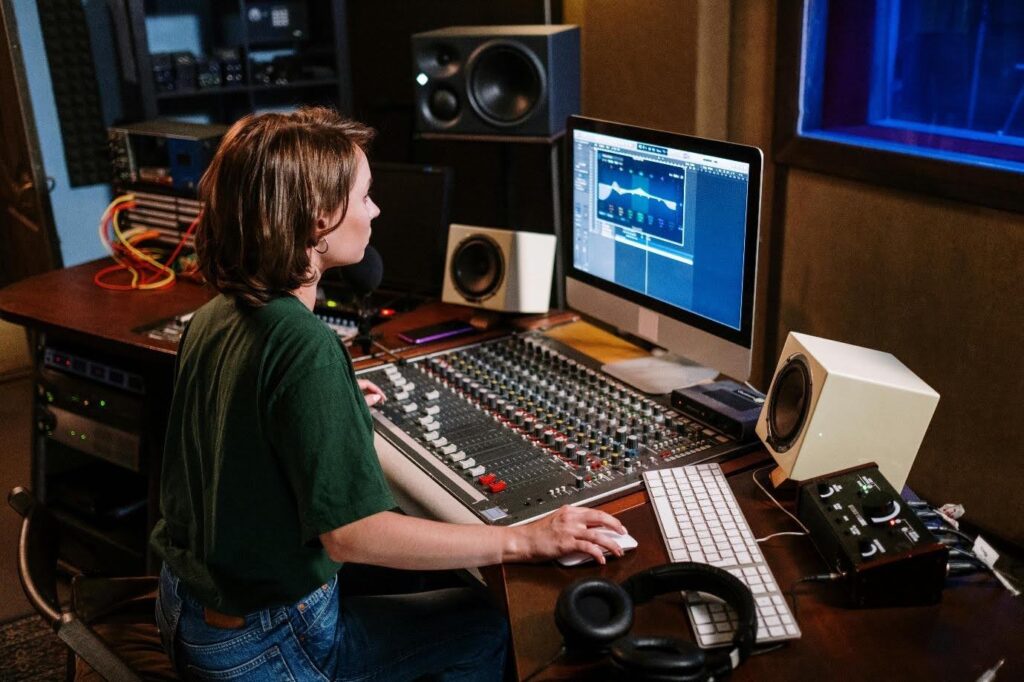 A woman works on the sound design of a film during post production