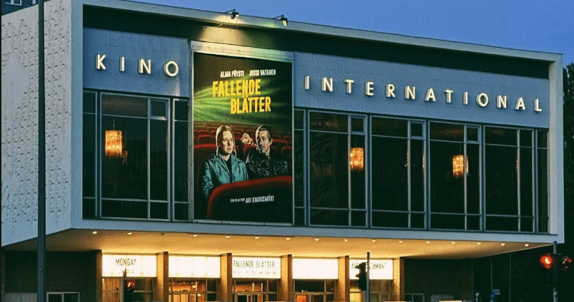 the front of the Kino International building with a poster for the film Fallende Blatter