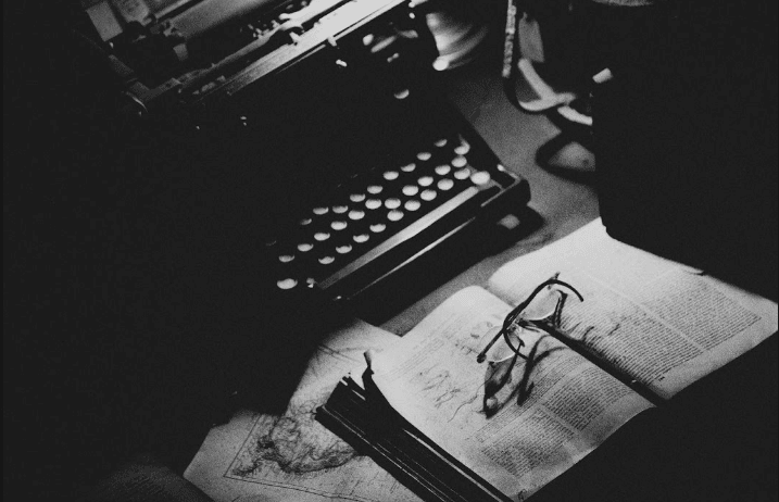 An old typewriter, an old book, some glasses (not sure if those are old)