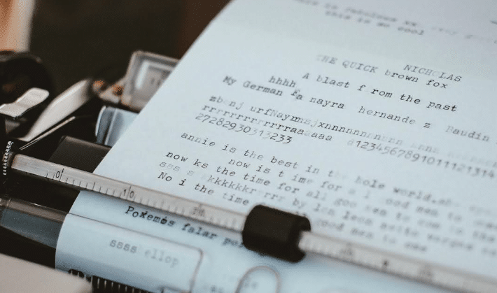 A script being written in a typewriter. A lot of typos present.