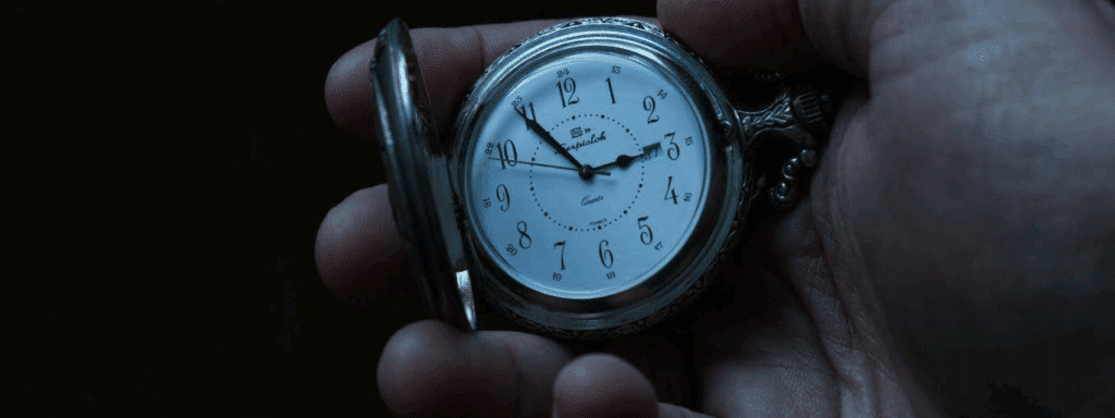 A photo showing a hand holding a stopwatch with old-timey numbering/lettering.