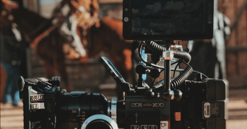 A camera sits on a movie set - it's outdoors, looks western.