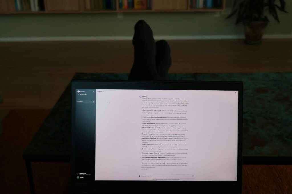 A shooting script is pulled up on the screen of a laptop. The user is clearly relaxing, as you can see their socked feet propped up in the background - probably relaxing on the couch