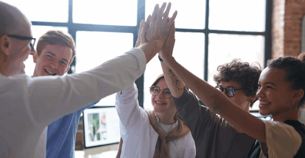 A group of people high-fiving. Really cringy. Sorry about it.
