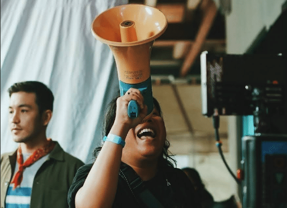 a woman on a film set with a megaphone