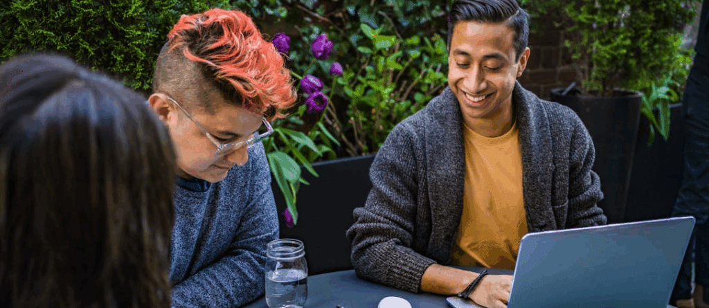 Free screenwriting software blog.

A diverse group sits at an outdoor table, one of whom has a laptop