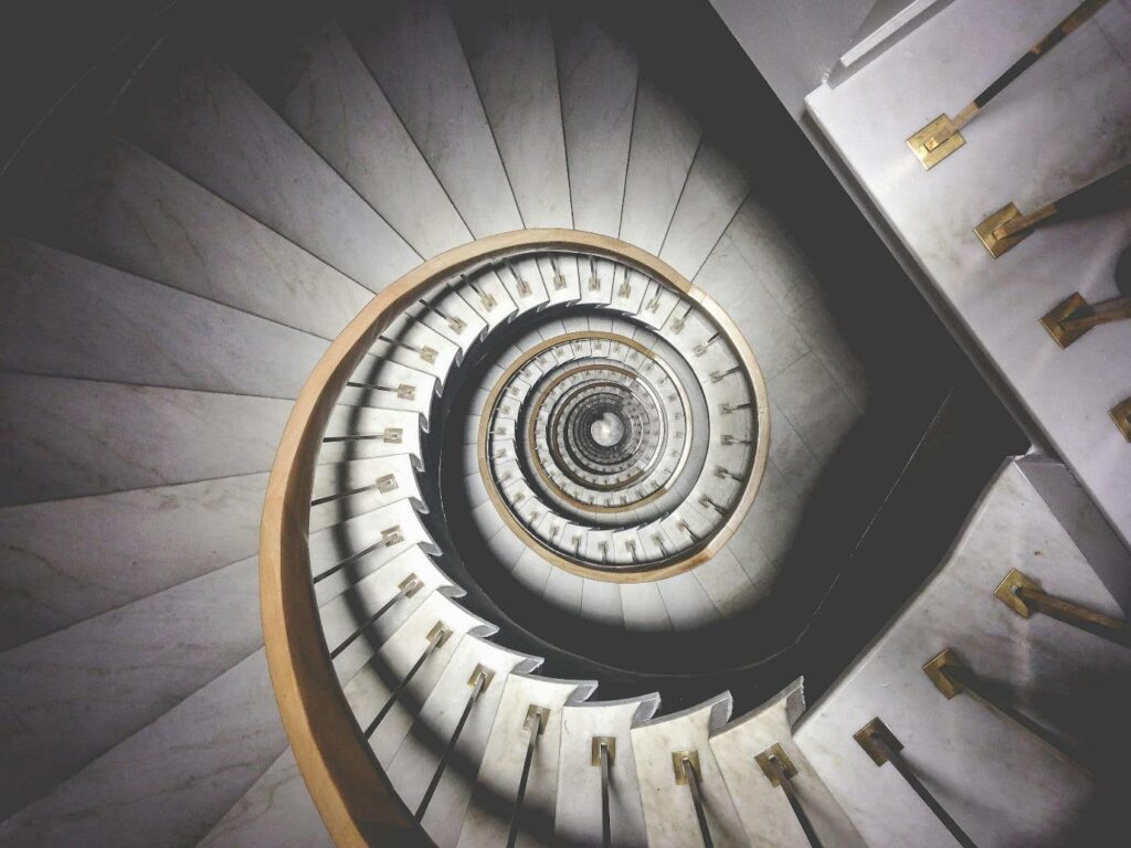 We are either looking down a spiral staircase, or looking up a spiral staircase. I think looking up, because this is a piece on RISING action.
